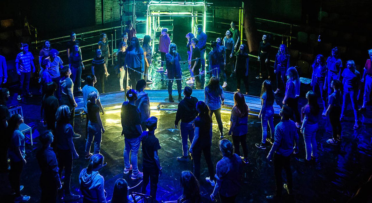 A group of people under a blue light