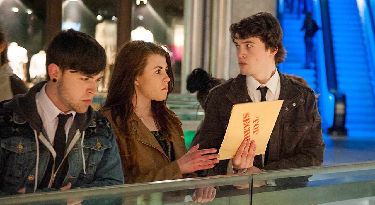 The people leaning on railings wearing shirts and ties