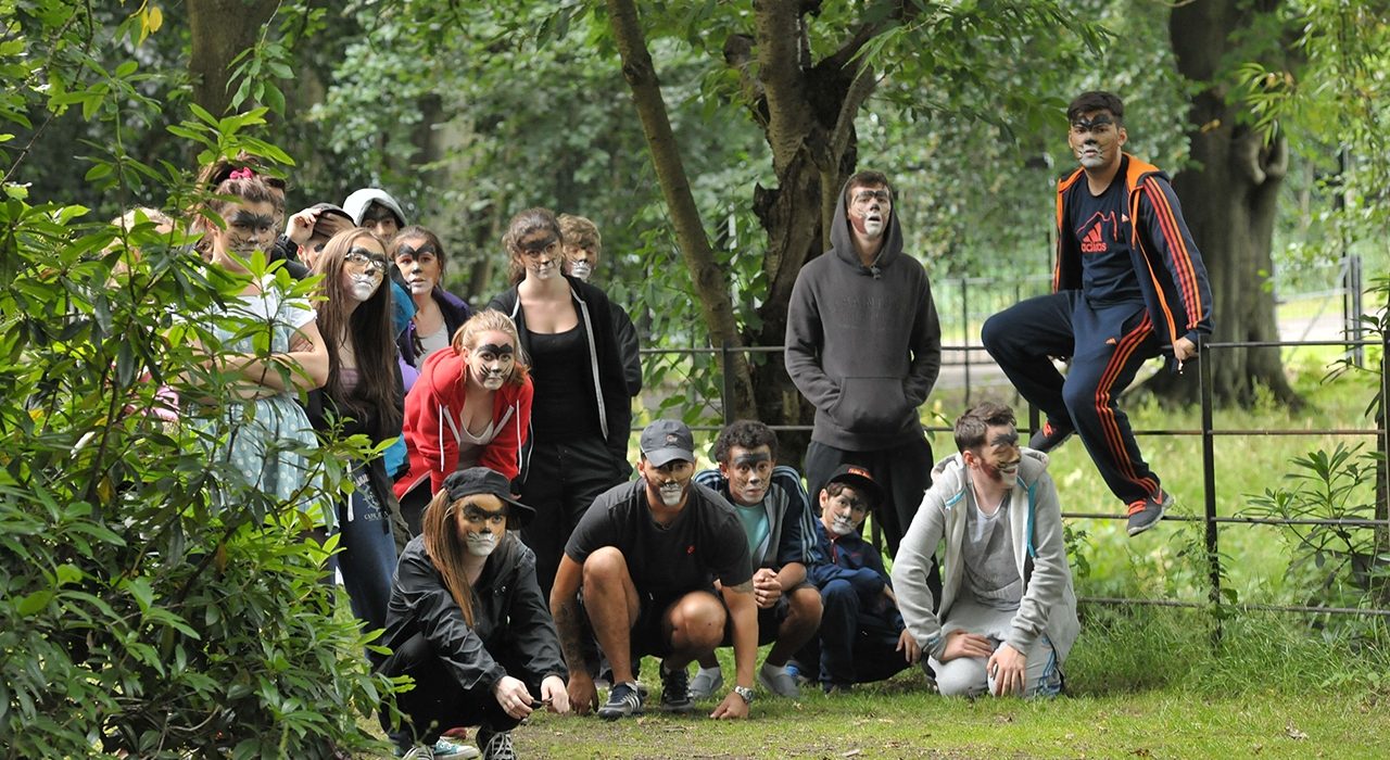 A group with animal face paint on in a park