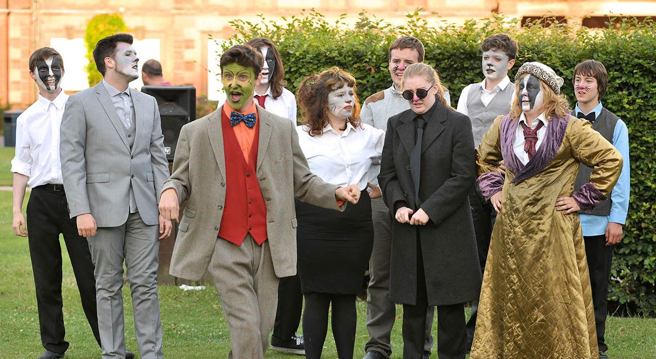 A group with animal face paint on in a park