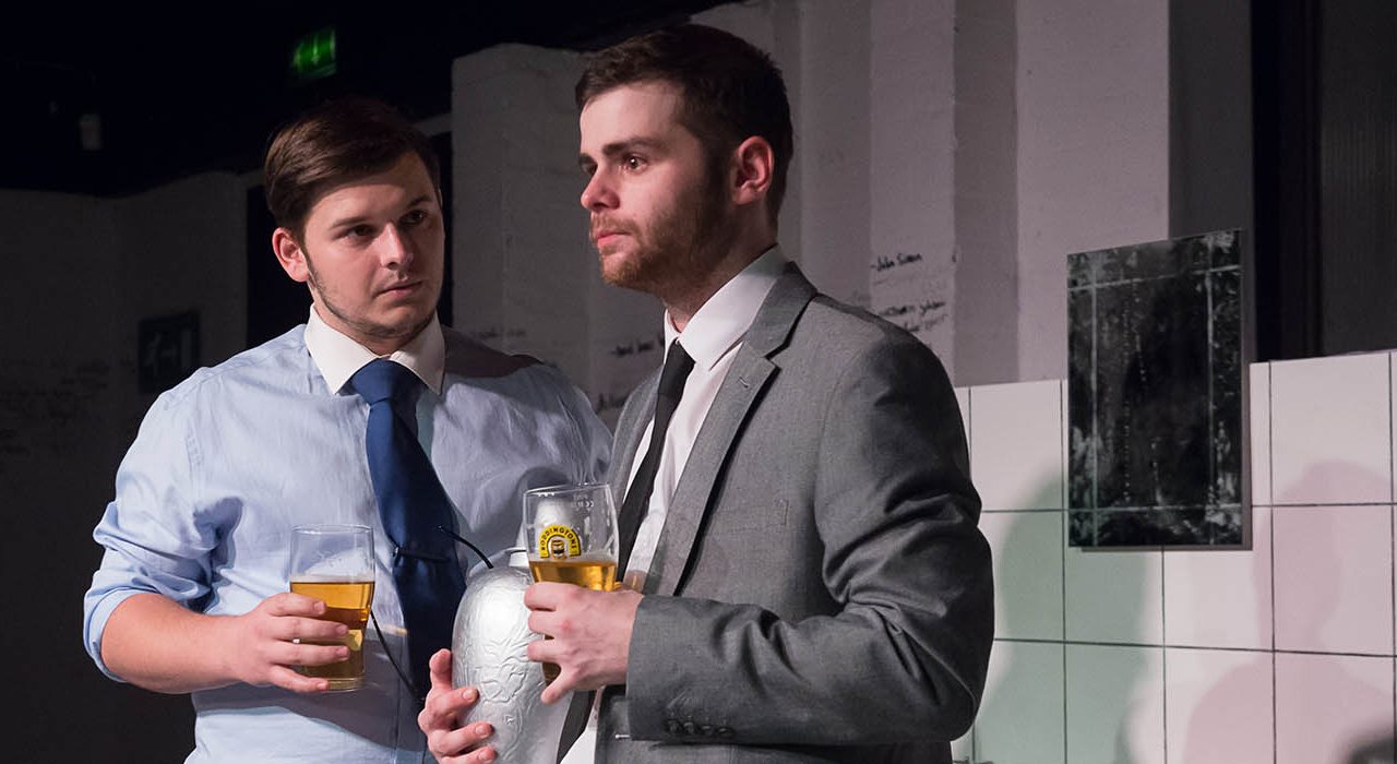 Two men in suits holding glasses