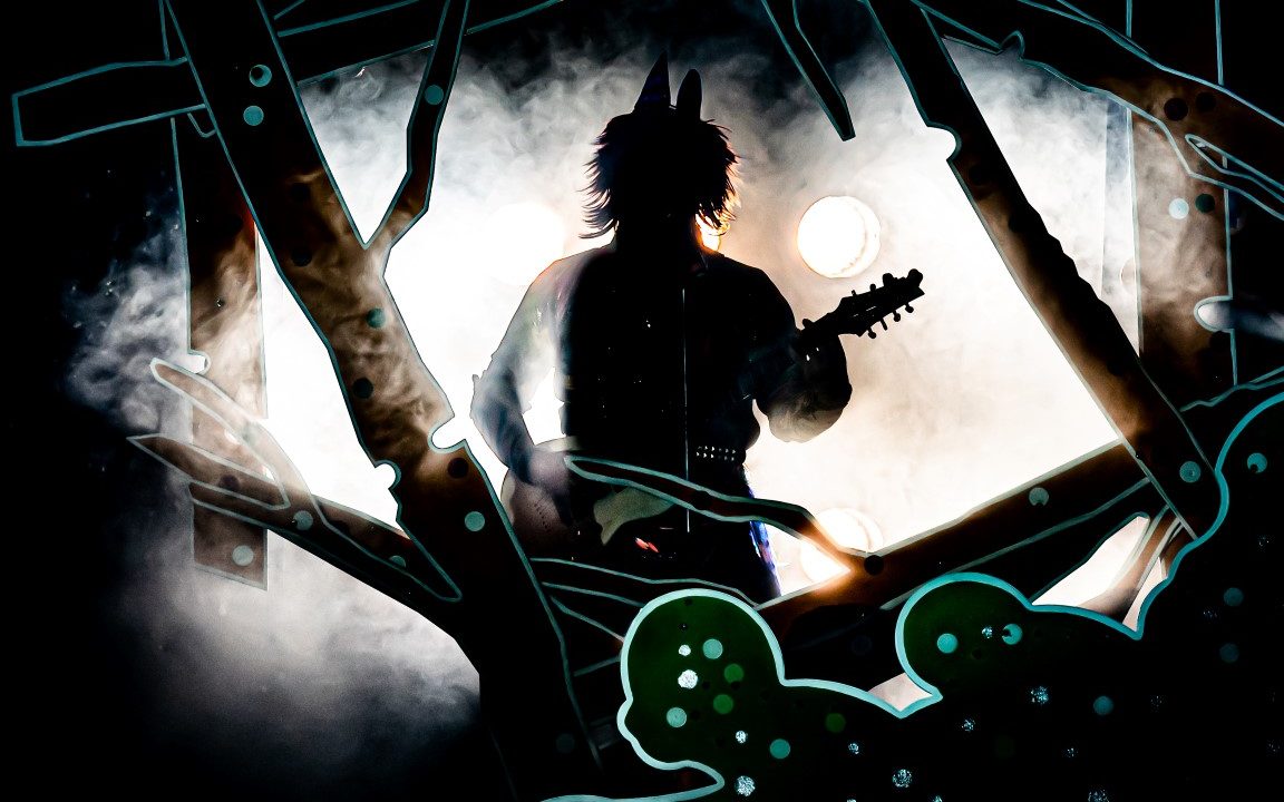 A silhouette of the big bad wolf holding a guitar