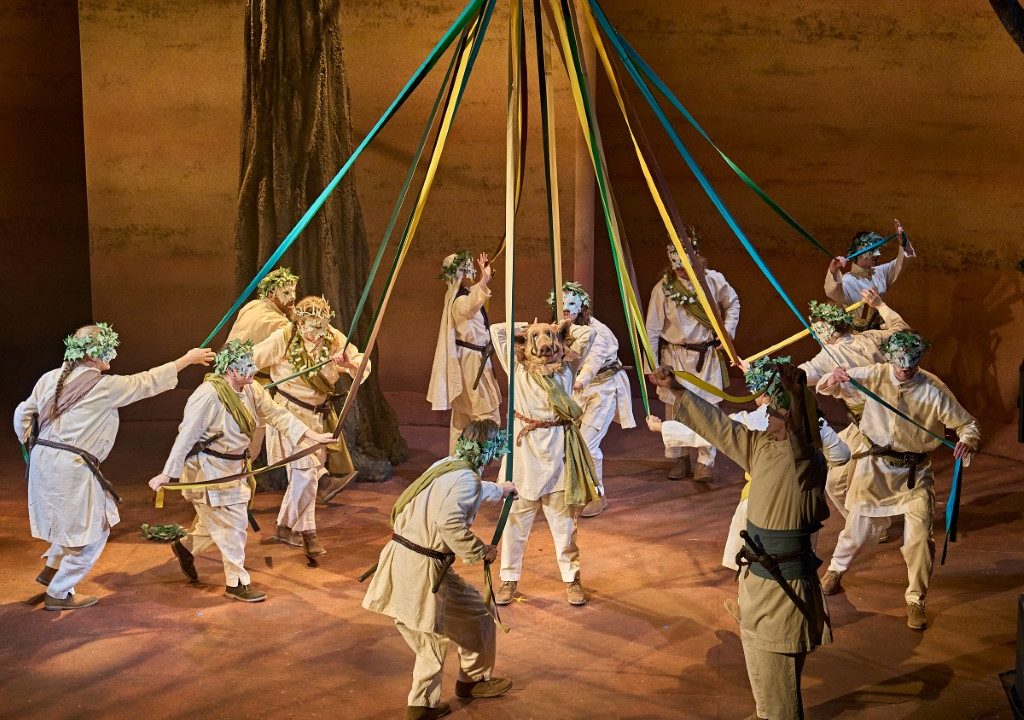 The cast dancing around a may pole