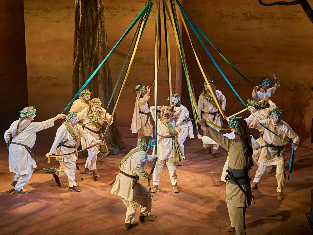 The cast dancing around a may pole