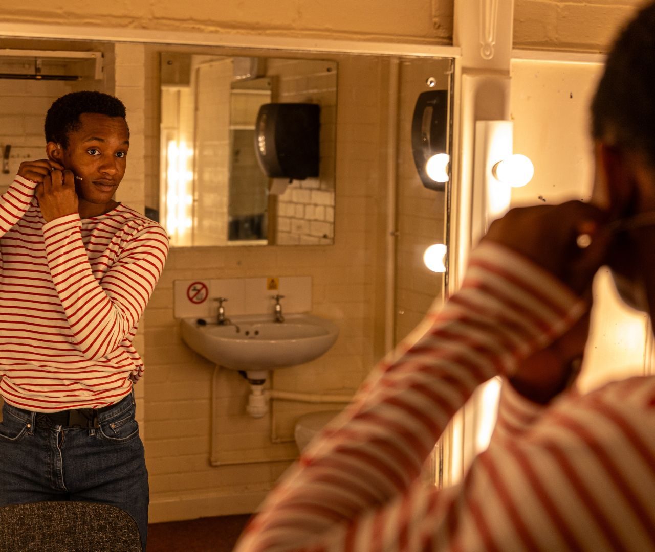 Pierre Hanson-Johnson preparing for stage in one of the dressing rooms. Photograph by Olivia Carroll.