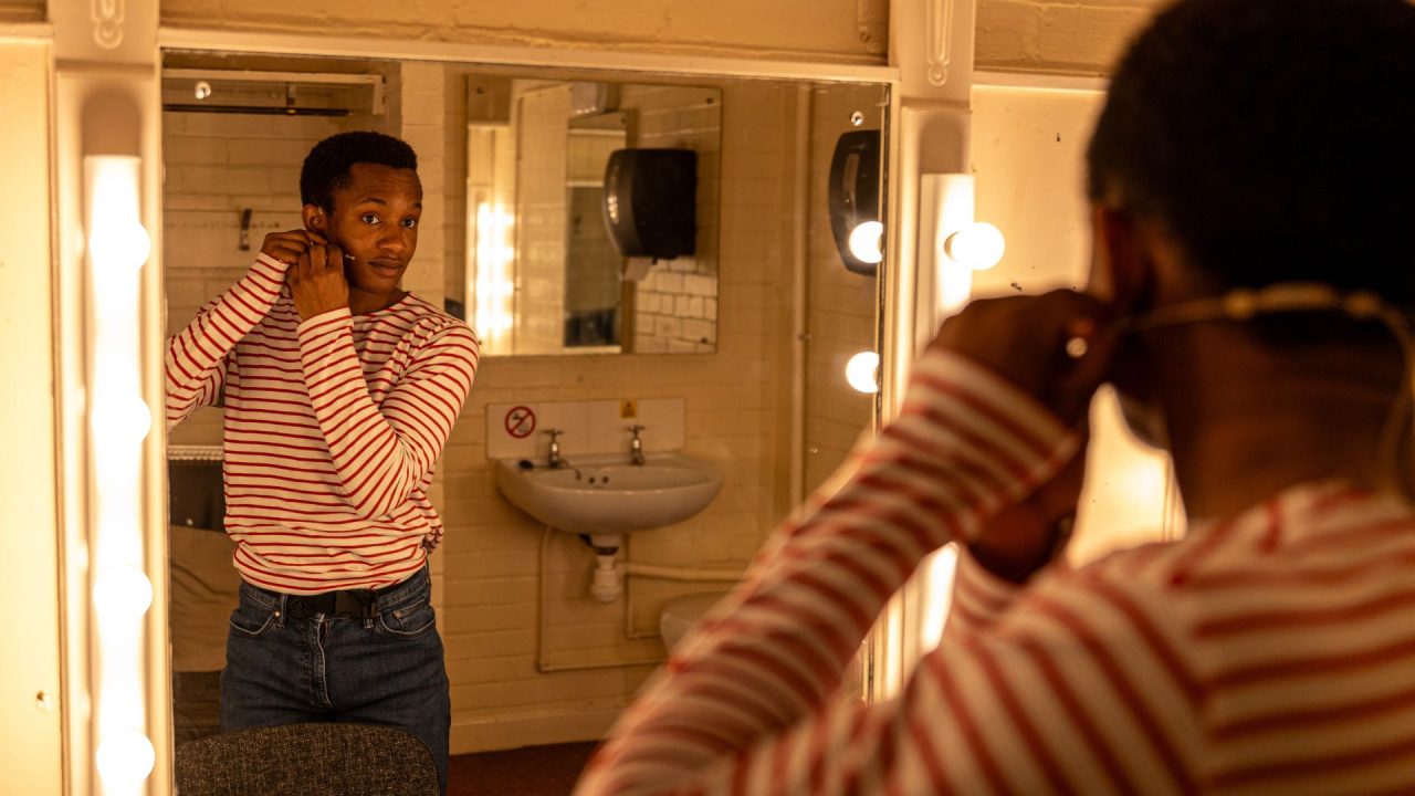 Pierre Hanson-Johnson preparing for stage in one of the dressing rooms. Photograph by Olivia Carroll.